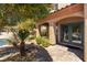 Charming front porch with stone pillars, a paved walkway, a small rock garden, and double glass entry doors at 2434 Amoretti St, Henderson, NV 89052