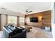 Cozy living room featuring wood accent wall, modern furniture, and ample natural light at 2434 Amoretti St, Henderson, NV 89052