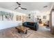 Comfortable living room with modern furnishings and open floor plan leading to kitchen at 2434 Amoretti St, Henderson, NV 89052