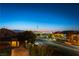 An elevated street view displays a glimpse of the city skyline against a colorful dusk backdrop at 2434 Amoretti St, Henderson, NV 89052