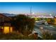 An elevated street view displays the city skyline against a colorful dusk backdrop at 2434 Amoretti St, Henderson, NV 89052