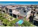 A backyard featuring a lounge area, manicured lawn, hot tub, patio dining set and covered patio at 2579 Speyburn Ave, Henderson, NV 89044