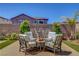 Charming backyard seating area with a decorative stone waterfall feature, creating a tranquil retreat at 2579 Speyburn Ave, Henderson, NV 89044