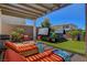 Relaxing backyard with a hot tub, grill, and comfortable lounge chairs under a shaded pergola at 2579 Speyburn Ave, Henderson, NV 89044