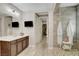 Bathroom featuring a stone-tiled shower with a glass door and a TV at 2579 Speyburn Ave, Henderson, NV 89044