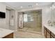 Bathroom featuring a stone-tiled shower with a glass door at 2579 Speyburn Ave, Henderson, NV 89044