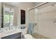 Bright bathroom with glass-enclosed shower, white tiles, and modern fixtures at 2579 Speyburn Ave, Henderson, NV 89044