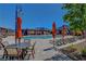 Community pool with shaded lounge chairs, dining tables, and a nearby pool house for residents' enjoyment at 2579 Speyburn Ave, Henderson, NV 89044