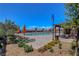Community pool area with lounge chairs, umbrellas, and lush landscaping on a sunny day at 2579 Speyburn Ave, Henderson, NV 89044