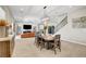 Open concept dining room view to the living room, staircase, and chandelier at 2579 Speyburn Ave, Henderson, NV 89044