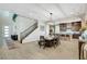 Open concept dining room with a dining table, modern chandelier, and wood staircase at 2579 Speyburn Ave, Henderson, NV 89044