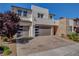 Beautiful home featuring a stone facade, desert landscaping, and a three-car garage at 2579 Speyburn Ave, Henderson, NV 89044