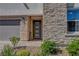 Close-up of front door with stone accents and desert landscaping at 2579 Speyburn Ave, Henderson, NV 89044
