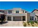 Stunning two-story modern home showcasing a beautiful stone and stucco exterior, with a well-manicured front yard at 2579 Speyburn Ave, Henderson, NV 89044