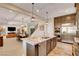 Open concept kitchen with granite countertops, a kitchen island, and stainless steel appliances at 2579 Speyburn Ave, Henderson, NV 89044