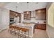Modern kitchen features granite countertops, a kitchen island with seating, and stainless steel appliances at 2579 Speyburn Ave, Henderson, NV 89044