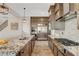 Modern kitchen with granite countertops, stainless appliances, and stylish light fixtures at 2579 Speyburn Ave, Henderson, NV 89044