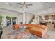 Spacious living room with a tan sectional sofa, decorative area rug, and view into the kitchen at 2579 Speyburn Ave, Henderson, NV 89044