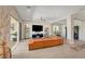Bright living room with an oversized sofa, modern entertainment center, and sliding glass doors at 2579 Speyburn Ave, Henderson, NV 89044