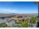 Scenic view of the neighborhood showcasing lush landscaping, pools, and mountain views at 2579 Speyburn Ave, Henderson, NV 89044