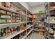 Well-stocked pantry with ample shelving and storage space for food items and kitchen essentials at 2579 Speyburn Ave, Henderson, NV 89044