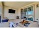 Spacious patio features comfortable seating, an outdoor TV, and sliding glass doors for indoor-outdoor living at 2579 Speyburn Ave, Henderson, NV 89044