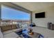 Relaxing patio features comfortable seating, an outdoor TV, and views of the surrounding mountains at 2579 Speyburn Ave, Henderson, NV 89044