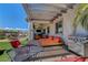 Shaded patio with lounge chairs and a grill, offering a perfect space for outdoor relaxation and entertaining at 2579 Speyburn Ave, Henderson, NV 89044
