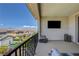 Expansive patio featuring comfortable seating, an outdoor TV, and views of the pool and mountains at 2579 Speyburn Ave, Henderson, NV 89044