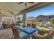 Inviting covered patio with stylish wicker furniture and a dining area, perfect for outdoor entertaining at 2579 Speyburn Ave, Henderson, NV 89044