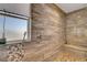 This stone-tiled shower has a shower seat and a shower niche at 2579 Speyburn Ave, Henderson, NV 89044