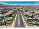 Aerial view of neighborhood featuring landscaping, community pool, and mountain views at 2579 Speyburn Ave, Henderson, NV 89044