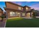 Beautiful home backyard featuring lush artificial turf, covered patio and neutral stucco exterior at 2717 Mona Lisa St, Henderson, NV 89044
