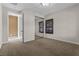 Neutral bedroom featuring mirrored closet doors and dark wood-toned plantation shutters at 2717 Mona Lisa St, Henderson, NV 89044