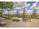 Outdoor community space features tables, chairs, desert landscaping, walking path, and mountain views at 2717 Mona Lisa St, Henderson, NV 89044