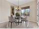 A cozy dining area features a round table, chandelier, and a window with views of the backyard at 2717 Mona Lisa St, Henderson, NV 89044