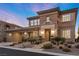 Luxurious two-story home with desert landscaping, attached garage, and covered front porch at 2717 Mona Lisa St, Henderson, NV 89044