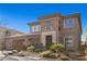 Luxurious two-story home with desert landscaping, attached garage, and covered front porch at 2717 Mona Lisa St, Henderson, NV 89044