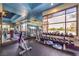 Well-equipped gym with weight machines, free weights, and floor-to-ceiling windows with a pool view at 2717 Mona Lisa St, Henderson, NV 89044