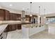 Modern kitchen features stainless steel appliances, granite counters, and a large center island with pendant lighting at 2717 Mona Lisa St, Henderson, NV 89044