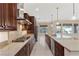 A kitchen with stainless steel appliances, granite countertops, a large island with sink and pendant lighting at 2717 Mona Lisa St, Henderson, NV 89044