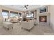 Bright living room with large windows, a fireplace, and neutral furniture, creating an inviting space at 2717 Mona Lisa St, Henderson, NV 89044