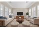 Bright living room with neutral furniture, plantation shutters, and a stylish rug, perfect for relaxation and gatherings at 2717 Mona Lisa St, Henderson, NV 89044