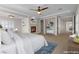 Virtual staging shows spacious main bedroom with fireplace, ceiling fan, and access to hallway at 2717 Mona Lisa St, Henderson, NV 89044