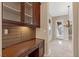 Built-in desk with cabinets, decorative backsplash, and lighting adjacent to the entryway at 2717 Mona Lisa St, Henderson, NV 89044