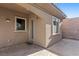 Patio area with stamped concrete and beige walls, providing a private outdoor space at 2717 Mona Lisa St, Henderson, NV 89044