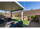 Backyard features a patio area, synthetic grass, raised garden beds, and play structures at 2928 Sunday Silence Rd, North Las Vegas, NV 89086