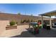 Backyard features synthetic grass, play structures, a privacy wall, and a covered patio at 2928 Sunday Silence Rd, North Las Vegas, NV 89086