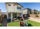 Backyard features a patio, synthetic grass, play structure, and a privacy wall at 2928 Sunday Silence Rd, North Las Vegas, NV 89086