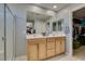 Bathroom featuring a double sink vanity and a glass-enclosed shower with a walk in closet on the side at 2928 Sunday Silence Rd, North Las Vegas, NV 89086